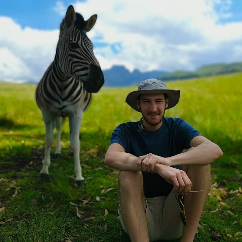 Gavin with posing with a Zebra.
